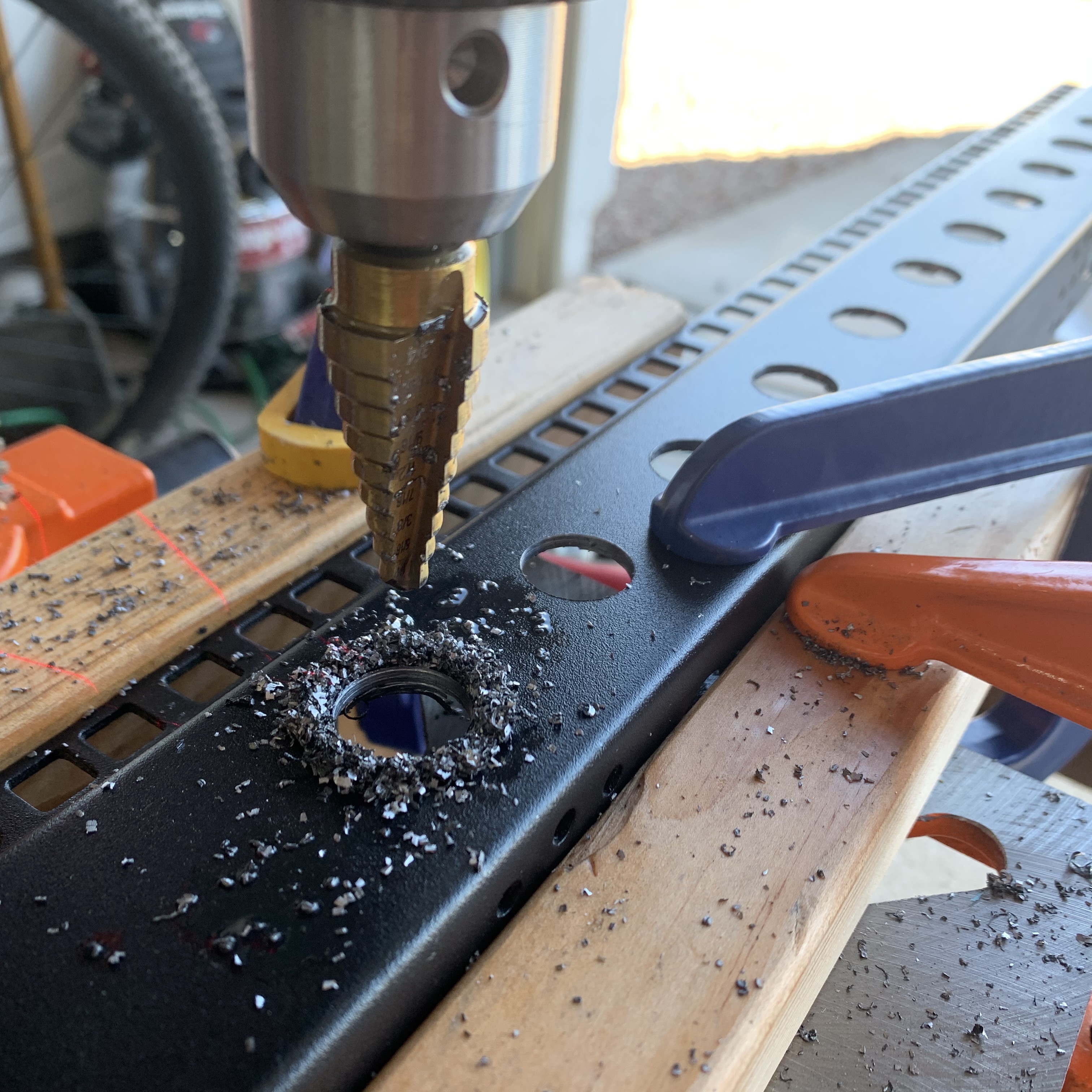 multiple holes drilled into server rack post