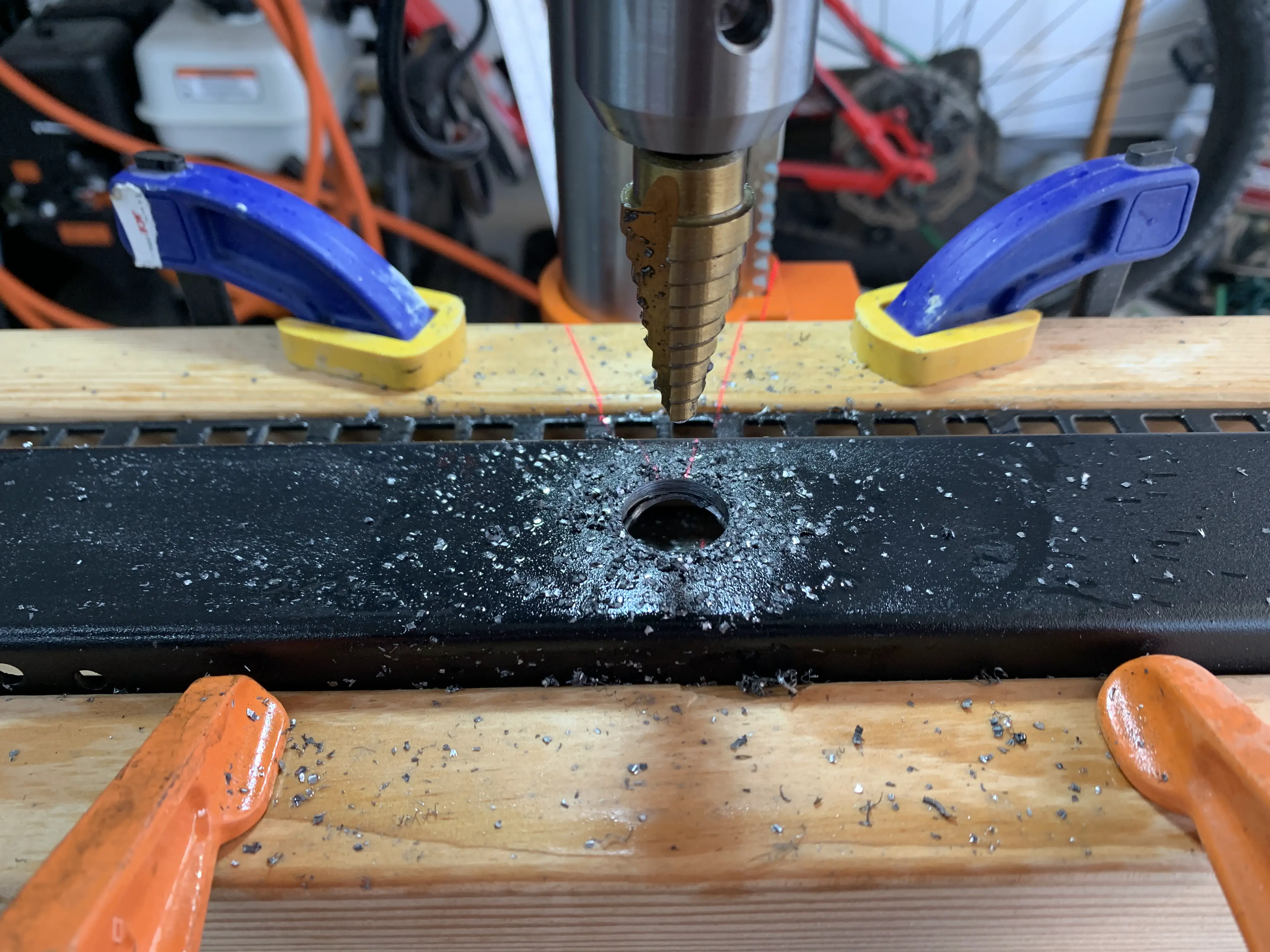 Drilling test hole with drill press in old server rack post